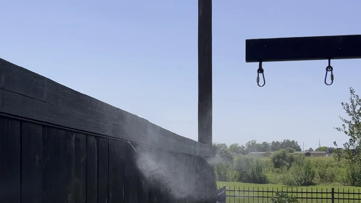 Fence-line mosquito misting nozzles installed by Texan Mosquito Systems along a residential backyard perimeter