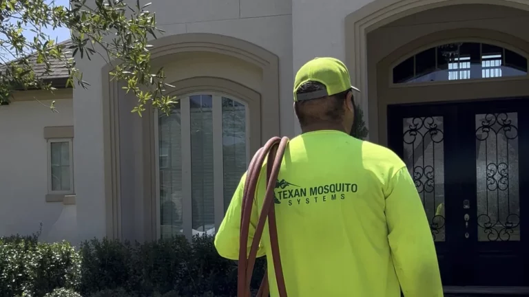 Texan Mosquito Systems technician calibrating a backyard mosquito misting system during a routine service visit